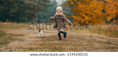 Girl Playing With Her Dog In Autumn Imagine de stoc © Stasia04