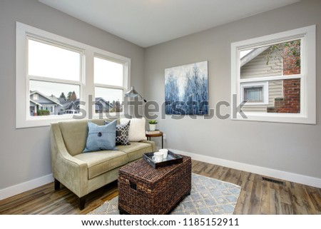 Stockfoto: Cozy Seating Area With A Rattan Trunk Coffee Table And An Ivory Sofa
