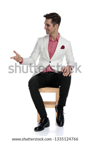 Stock photo: Seated Young Man Talking With Someone Besides Him And Gesticula