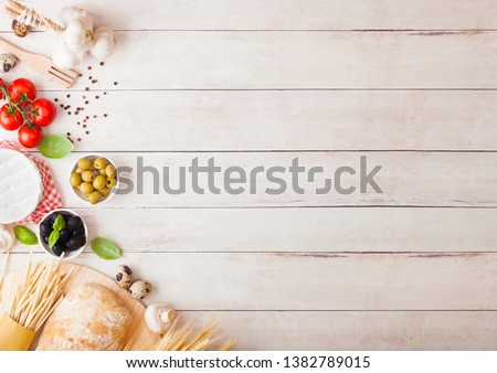 Foto d'archivio: Homemade Spaghetti Pasta With Quail Eggs With Bottle Of Tomato Sauce And Cheese On Wooden Background