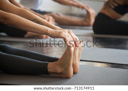 Stock fotó: Trainer Helping Student With Bending Exercise