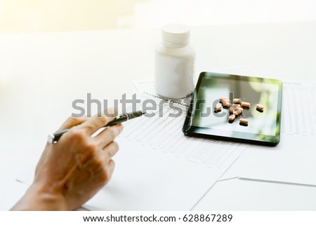 [[stock_photo]]: View Of Hands Doctor Pointing To Pad Drug And Equipment On For