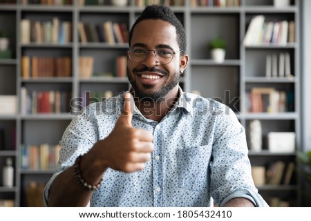 Foto stock: Image Of Pleased African American Guy Smiling And Showing Thumbs