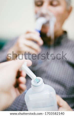 Foto stock: Preparation Of Compressor Nebulizer For Use On Senior Man With R