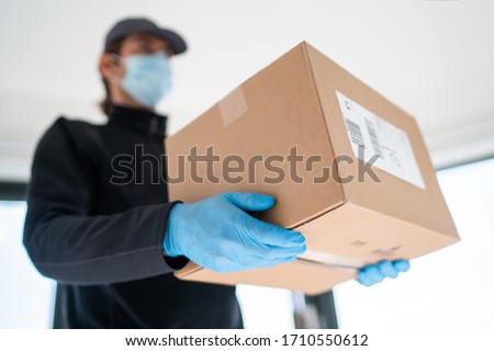 Home Delivery Shopping Box Man Wearing Gloves And Protective Mask Delivering Packages At Door Zdjęcia stock © Maridav