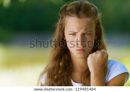 Stock photo: Unhappy Girl With The Fists On Her Face Against A White Background