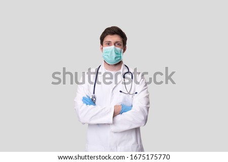 Foto d'archivio: Portrait Of Doctor With Surgical Mask On Isolated On White Backg