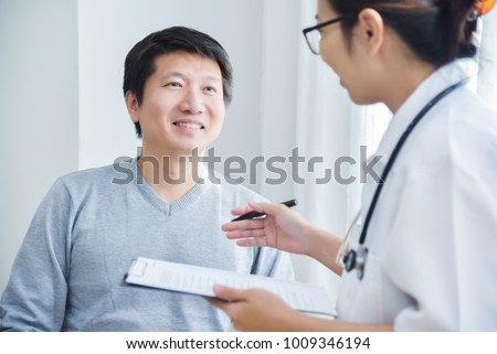 Foto stock: Female Doctor Writing Notes On Clipboard Paper During Medical Ex