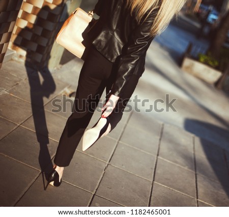 Stock photo: Girl In A Black Leather Jacket Walks Through The City