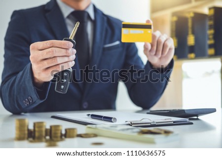 Salesman Holding A Key Credit Card And Calculating A Price Of S Stock foto © Freedomz