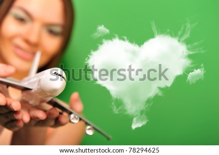 Stock photo: Pretty Young Woman Playing With Plastic Airplane On Green Backgr