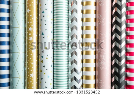 Stock photo: Gift Boxes And Rolls Of Wrapping Paper With Multicolored Streame