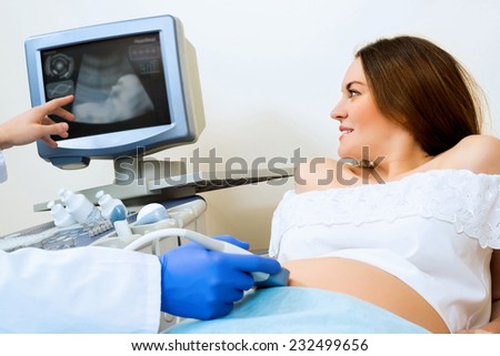 Foto d'archivio: Young Pregnant Woman In Ultrasound Examination Measuring Blood Pressure
