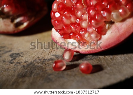Сток-фото: Pomegranates Have Broken Into Pieces With Red Berries On A Porcelain Plate On A White Background