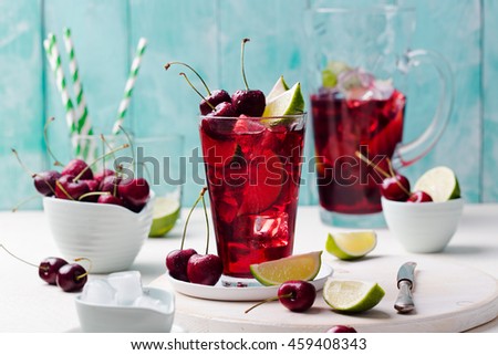 Imagine de stoc: Cherry Limeade Lemonade Cola Cocktail In A Tall Glass On White Turquoise Background Copy Space