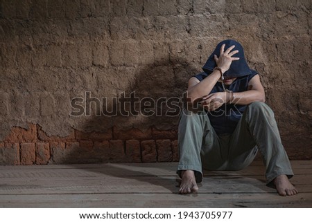 Stockfoto: Arrested Male Criminal With Handcuffs Facing Prison Wall