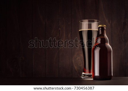 Foto stock: Brown Beer Bottle Belgian Steinie And Glass Weizen With Porter On Dark Wood Board Vertical Mock Up