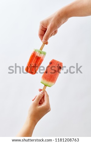 Creative Food Composition Of A Fruit Ice Cream In A Female Hand And A Juicy Piece Of Watermelon On A Stockfoto © artjazz