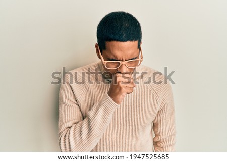 Foto d'archivio: Portrait Of Ill African American Guy Wearing Sweater And Scarf G