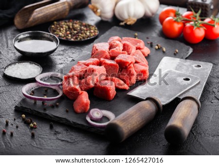 Zdjęcia stock: Raw Lean Diced Casserole Beef Pork Steak On Chopping Board With Vintage Meat Hatchets On Wooden Back