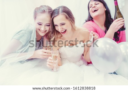 Сток-фото: Bride And Bridesmaids Having Fun And Drinking While Buying Wedding Dress