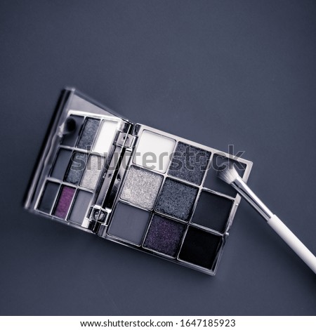 [[stock_photo]]: Eyeshadow Palette And Make Up Brush On Graphite Background Eye