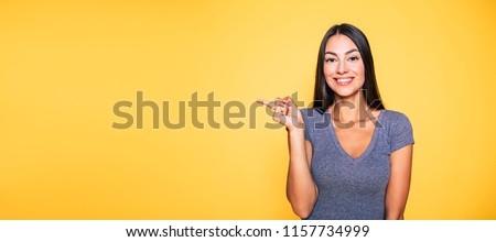 ストックフォト: Photo Of Cheerful Nice Woman Pointing Finger Aside And Drinking Soda