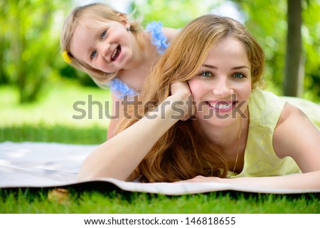 Stok fotoğraf: Young Mother And Her Cute Daughters Outdoors