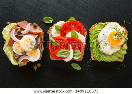 Stockfoto: Delicious Tasty Avocado Eggs And Tomato Cheese Toasts