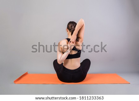 Zdjęcia stock: View From The Back Of A Girl With A Tattoo With An Orange Flower Strelitzia On A Gray Background Wit