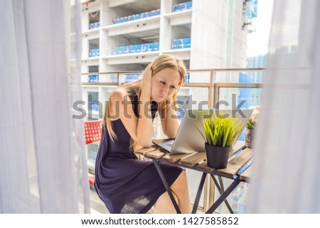 Сток-фото: Young Woman Trying To Work On The Balcony Annoyed By The Building Works Outside Noise Concept Air