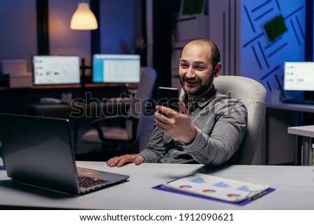 Stockfoto: Businessmen Discussing Data In Smartphone While Receptionist Using Computer