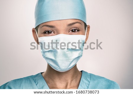 Foto stock: Covid 19 Coronavirus Pandemic Happy Asian Doctor Positive With Hope Wearing Surgical Mask And Blue P