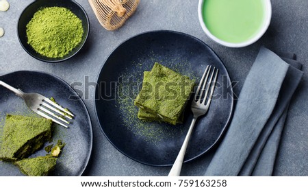 [[stock_photo]]: Matcha Green Tea Brownie Dessert With White Chocolate On A White Plate Grey Stone Background