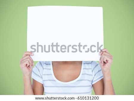 商業照片: Woman With Large Blank Card Over Face Against Green Background