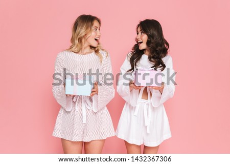 Foto stock: Shocked Happy Young Woman Posing Isolated Over Pink Wall Background Holding Lipstick