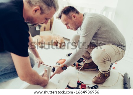 Foto stock: Two Wooden Doghouses With Dogs