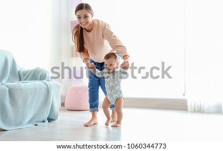 Stock photo: Happy Baby Learning To Walk With Mother Help