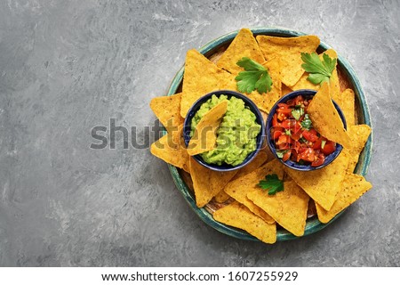 Foto stock: Green Homemade Guacamole With Tortilla Chips Salsa And Tequila