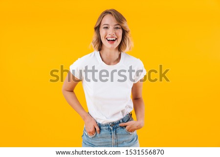 Foto stock: Photo Of Pleased Blond Woman In Basic Clothing Smiling And Point