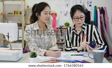 ストックフォト: Two Young Dressmaker Or Designer Colleagues Working As Fashion D