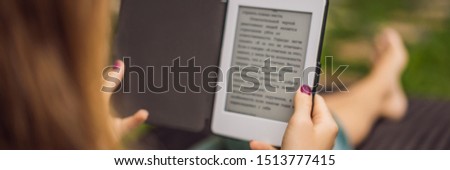 Stockfoto: Woman Reads E Book On Deck Chair In The Garden Banner Long Format