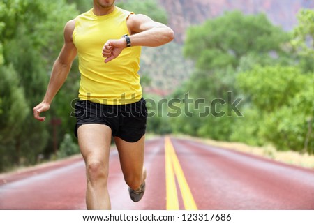 Stock photo: Male Runner Timing Workout