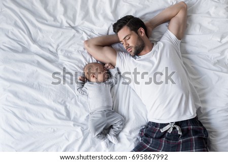 Zdjęcia stock: A Little Newborn Sleeping On The Parent Bed