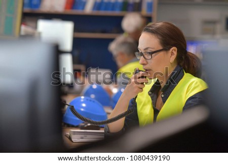 Stockfoto: Young Woman Controlling Process In The Factory With Male Worker