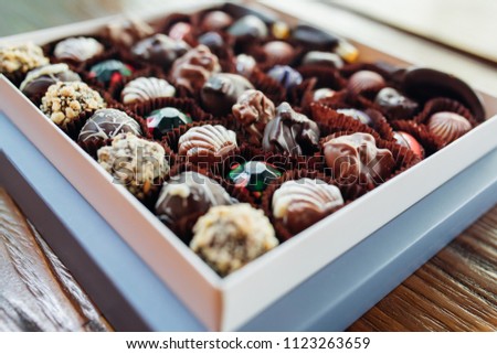 Stock foto: Various Snacks In Vintage Wooden Box On Black Background Onion Ringsnachos Salty Peanuts With Pot