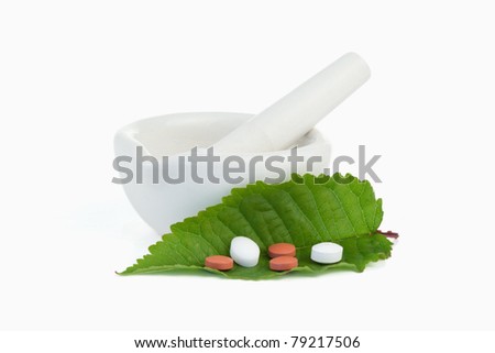 Stok fotoğraf: Mortar And Pestle With Pills On A Leaf Against A White Background