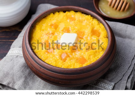 Stok fotoğraf: Millet Porridge With Pumpkin In A Clay Bowl On A Rustic Wooden Background