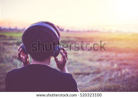 Stok fotoğraf: Blonde Sports Woman In Park Outdoors Listening Music With Headphones