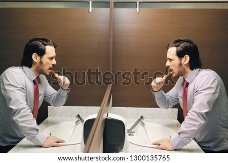 ストックフォト: Business Man Brushing Teeth After Lunch Break In Office Bathroom